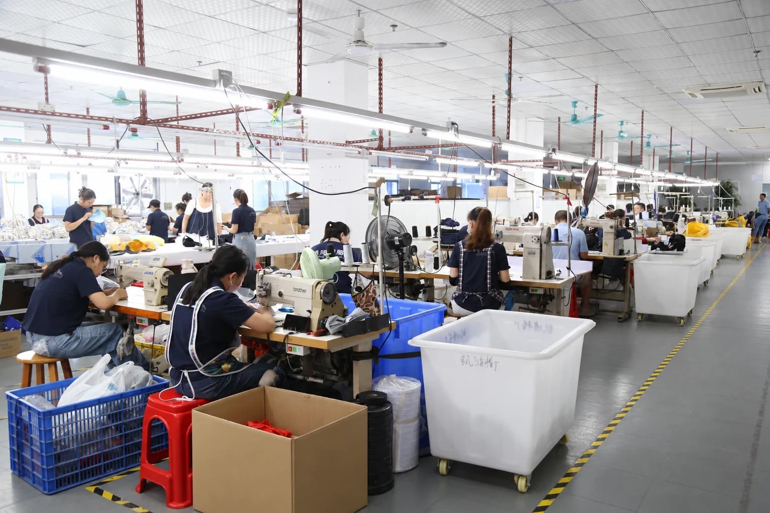 Headwear sewing team working across production tables