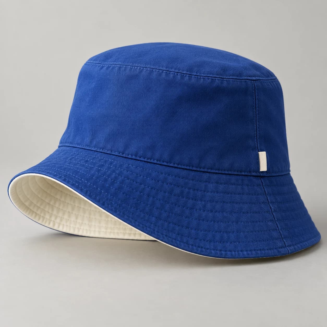 AI-generated reversible bucket hat design reference illustrating dual-face crown / all-around brim