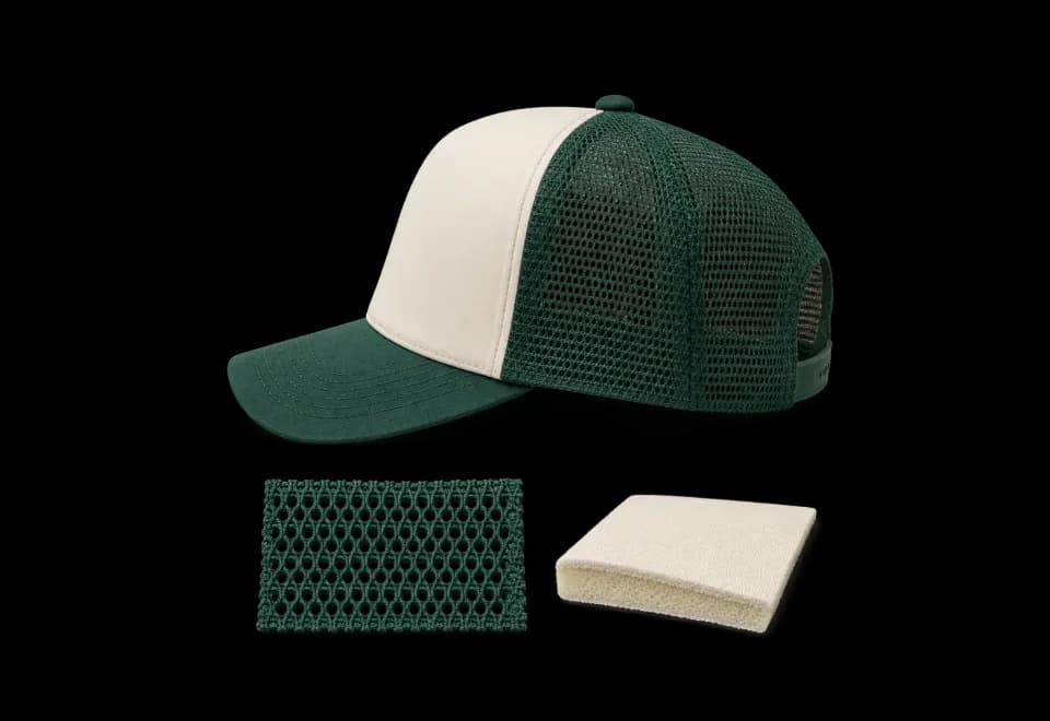 Cream and green trucker cap with mesh and foam-backed fabric swatches
