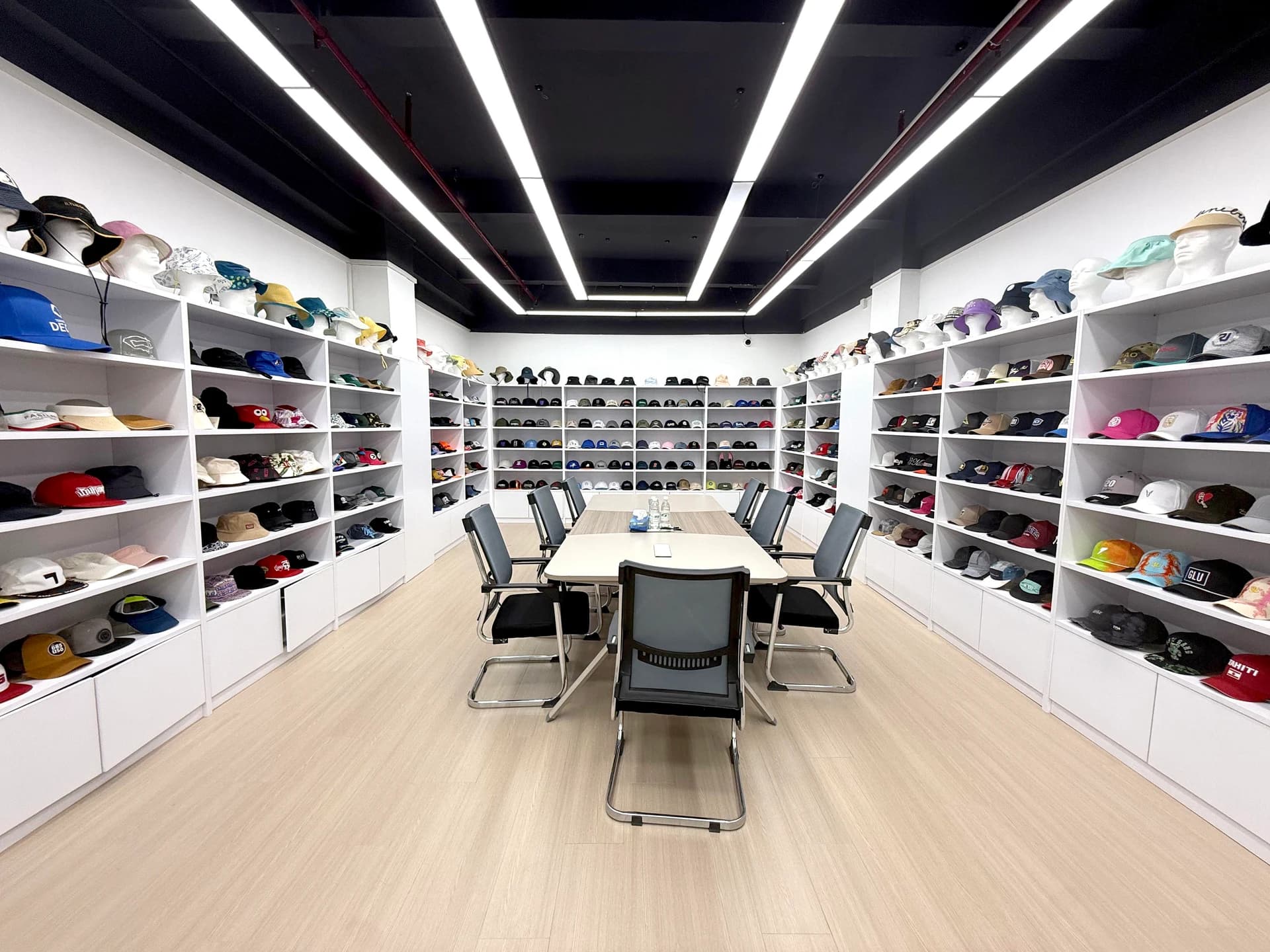 Headwear sample showroom with a discussion table